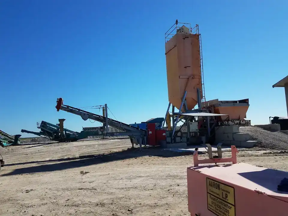 The batch plant and crusher, with the yard's own yellow sign in the foreground