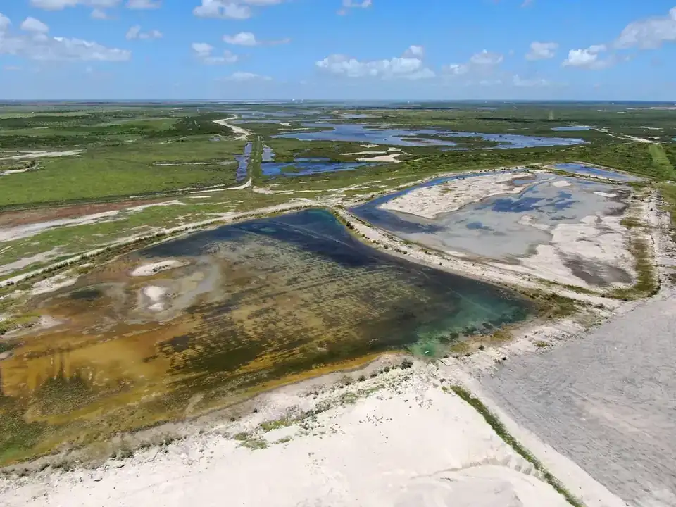 Aerial view of the yard's edge meeting the coastal wetland at Aransas Pass