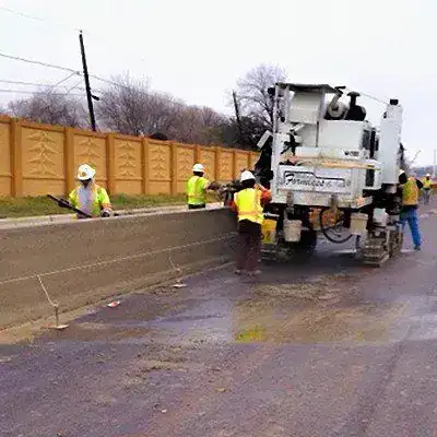 A slipform paver laying a textured barrier wall panel